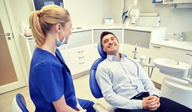 man smiling with dental hygienist