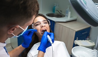 woman getting root canal in Carrollton 