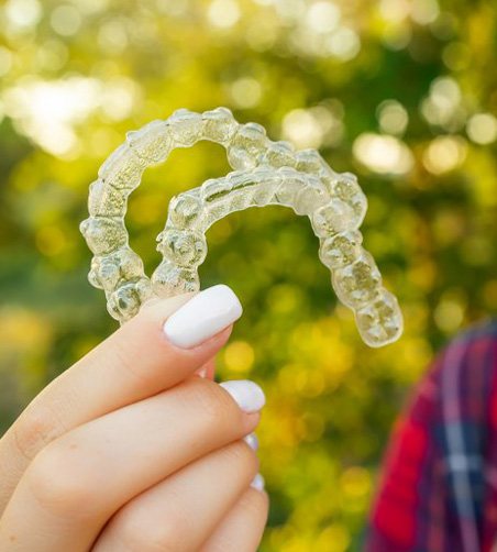 Smiling teen shows off clear aligners