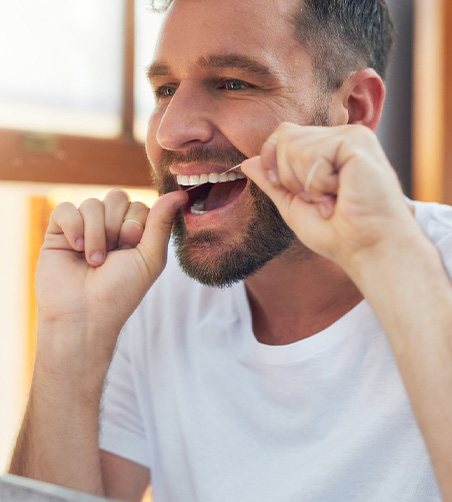Man flossing his teeth