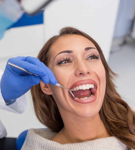 Woman in dental chair having her teeth examined