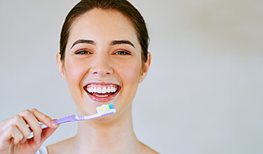happy woman brushing teeth