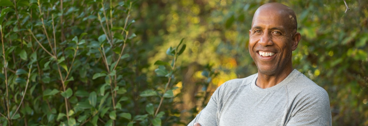 Man standing among plants and smiling