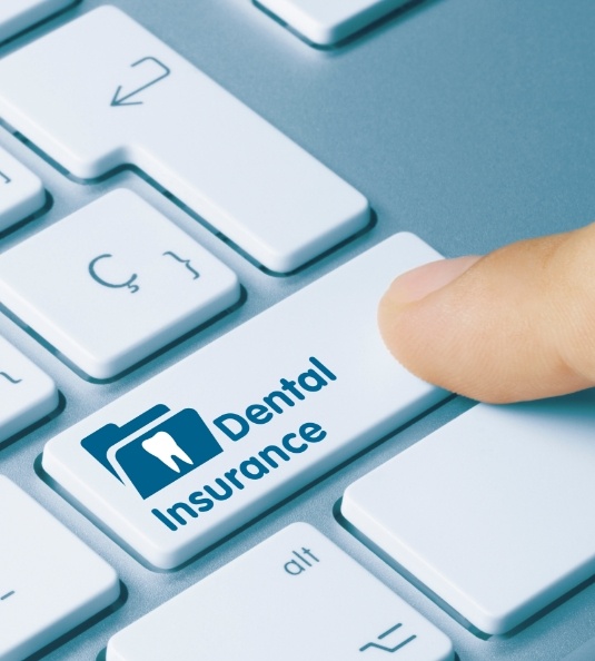Hand holding icon of tooth with umbrella