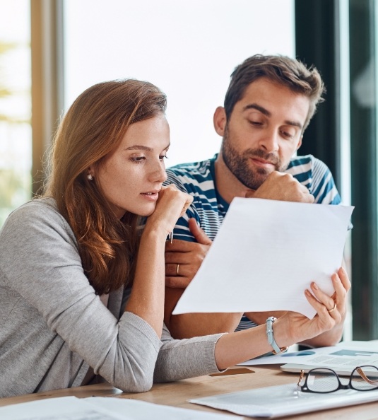 Man and woman looking at sheet of paper
