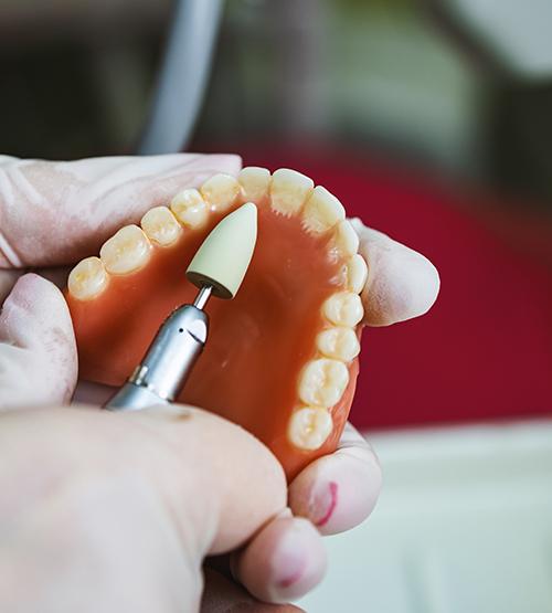 Technician working on full denture