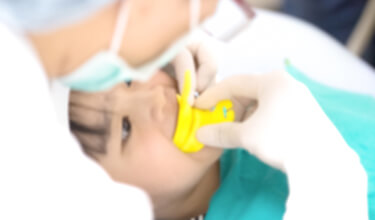 kid in a dental chair receiving treatment