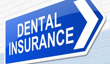 Dental insurance sign on white brick wall
