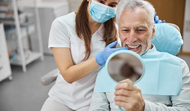 Older man visiting an implant dentist in Carrollton