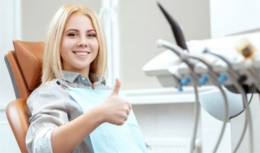 a patient giving thumbs up after IV dental sedation