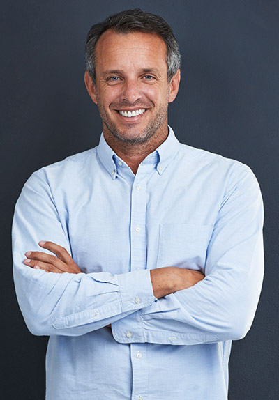 Smiling man standing with arms crossed
