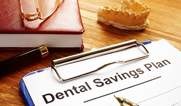 a dental savings plan sign-up sheet on a clipboard