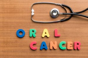"oral cancer" spelled out on a desk