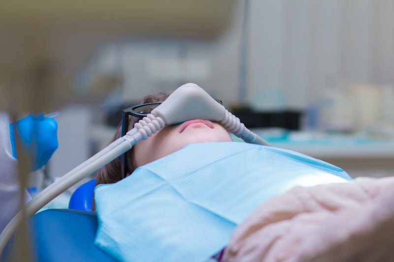 patient with glasses wearing a nitrous mask